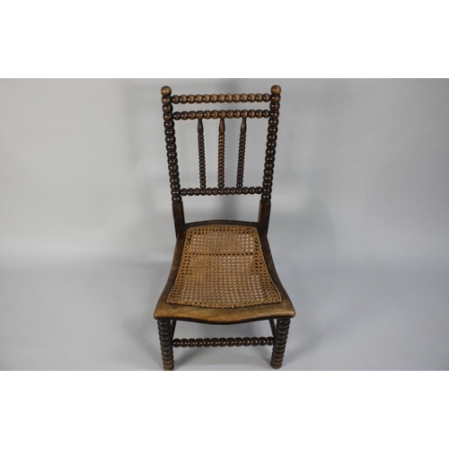 369 - A 19th Century Slipper Chair with Bobbin Turned Back over a Caned Seat, 80cms High