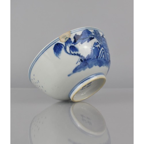 30 - A Chinese Porcelain Blue and White Bowl decorated with River Village Scene and Central Bird in Branc... 