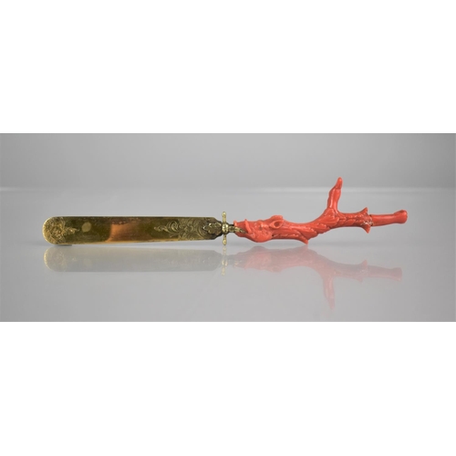 334 - A 19th Century Coral Handled and Unmarked Gilt Metal Page Turner, The Handle of Claw Form incorporat... 