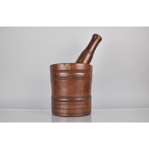 214 - A Large 19th Century Heavy Treen Pestle and Mortar, Both of Turned and Ribbed Form, Pestle 29cms Lon... 