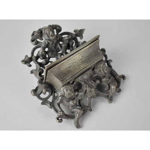 236 - A Cast Metal Wall Mounting Match Holder with Scrolled and Pierced Back with Gnomes, 10x13cms High