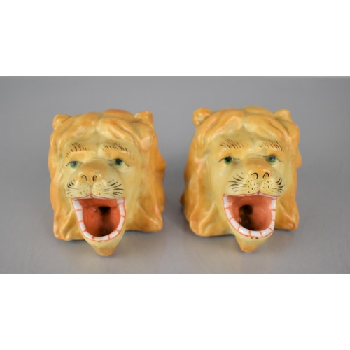 311 - A Pair of Continental Porcelain Inkwells in the Form of Lion Heads, 6cms High