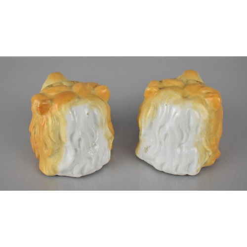 311 - A Pair of Continental Porcelain Inkwells in the Form of Lion Heads, 6cms High