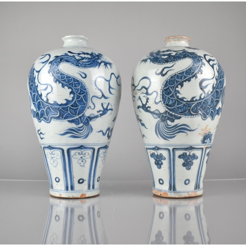 408 - A pair of Blue and White Vases decorated with Dragons Amongst Scrolls and Clouds, 30cms High