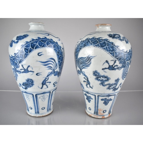 408 - A pair of Blue and White Vases decorated with Dragons Amongst Scrolls and Clouds, 30cms High