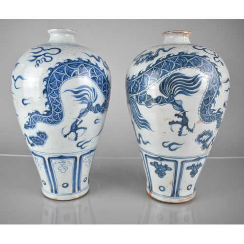 408 - A pair of Blue and White Vases decorated with Dragons Amongst Scrolls and Clouds, 30cms High