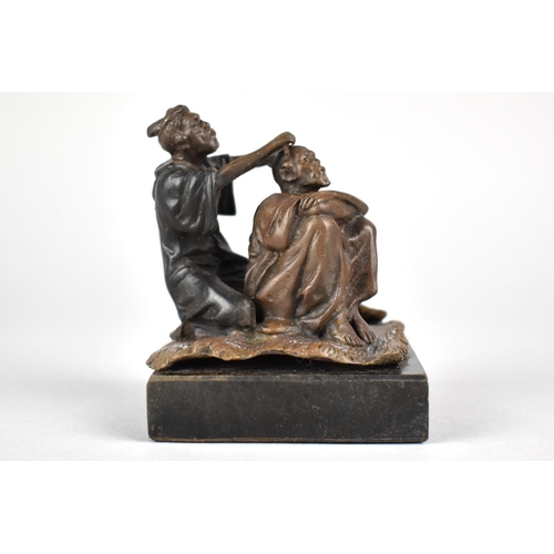 16 - A Bronze Figural Study of Barber and Client Sat on Rug Set on Square Slate Base, 8cms High