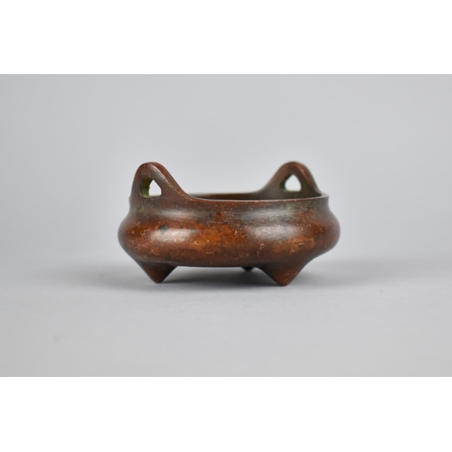 256 - A Small Reproduction Chinese Bronze Censer of Squat Form with Lug Handles, Raised on Tripod Supports... 