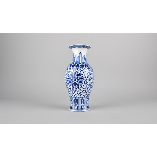 268 - A Chinese Blue and White Baluster Vase Decorated in a Floral Motif, 20.5cm high