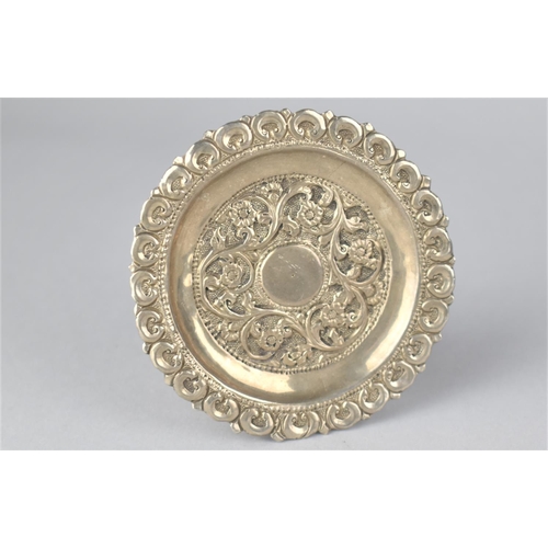 387 - An Islamic White Metal Dish with Floral Repousse Decoration, 8.5cm Diameter