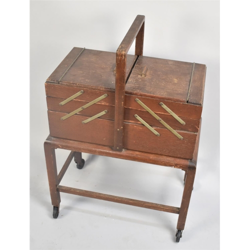 80 - An Edwardian Oak Cantilevered Sewing Box on Trolley Stand, 49cms Wide