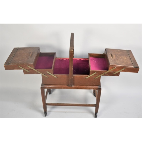 80 - An Edwardian Oak Cantilevered Sewing Box on Trolley Stand, 49cms Wide