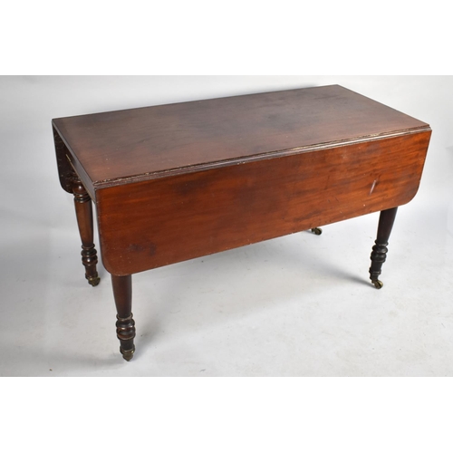 406 - A 19th Century Mahogany Pembroke Table on Turned Caster Supports, 121cm x 56.5 x 71cm high