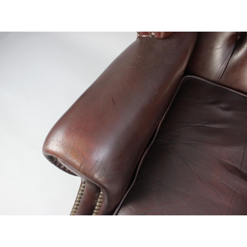 422 - A Leather Effect Buttoned Back Wing Armchair