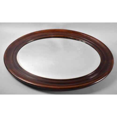 288 - A Mahogany Framed Oval Wall Mirror with Bevel Cut Glass, 65x54cms