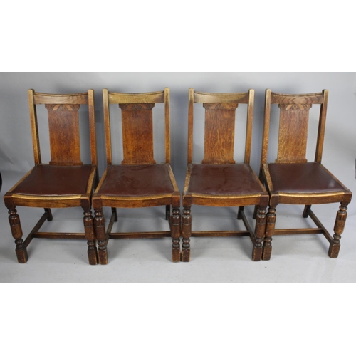 434 - A Set of Four Mid 20th Century Oak Framed Dining Chairs with Faux Leather Pad Seats