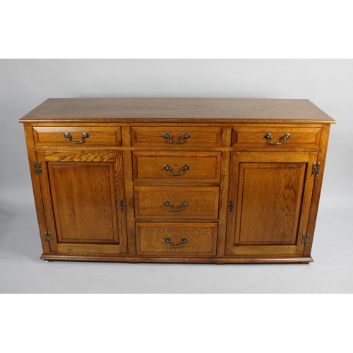 470 - A Mid 20th Century Oak Sideboard with Centre Cutlery Drawer over Three Short Drawers, Flanked Either... 