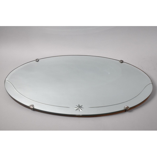 523 - An Oval Bevel Frame and Star Cut Wall Mirror, 60x35cms