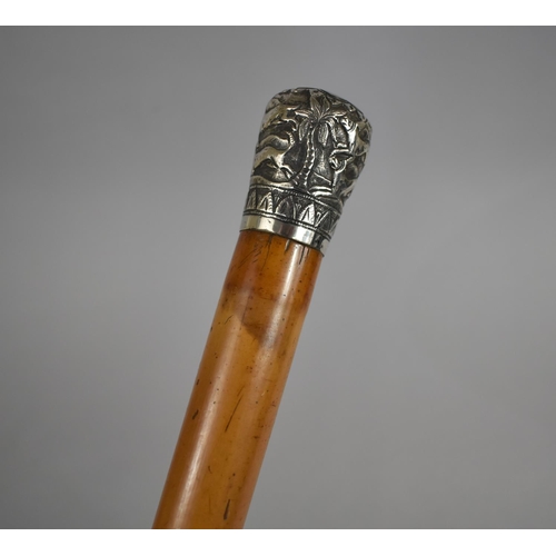 29 - A Colonial Malacca Walking Cane with White Metal Top Decorated with Palm Trees and Hunting Dogs