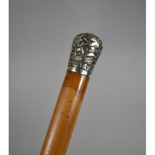 29 - A Colonial Malacca Walking Cane with White Metal Top Decorated with Palm Trees and Hunting Dogs