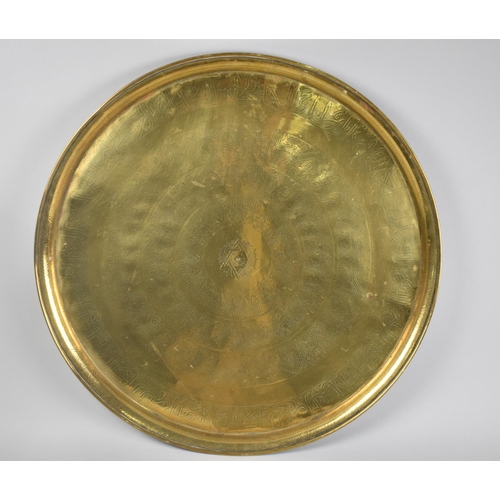 84 - A Large Circular Middle Eastern Tray with Islamic Engraving, 57cms Diameter