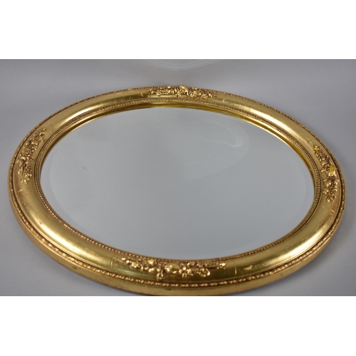 97 - A Modern Gilt Framed Oval Wall Mirror, Some Condition Issues to Bottom Floral Moulding, 59x49cms