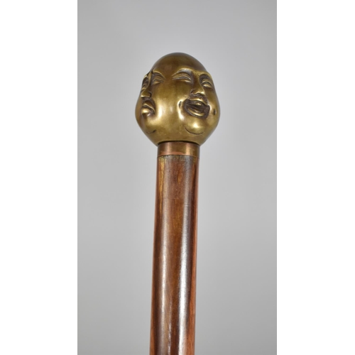 176 - A Reproduction Walking Cane with Four Faced Buddha Handle