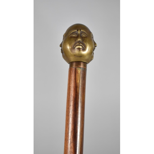 176 - A Reproduction Walking Cane with Four Faced Buddha Handle