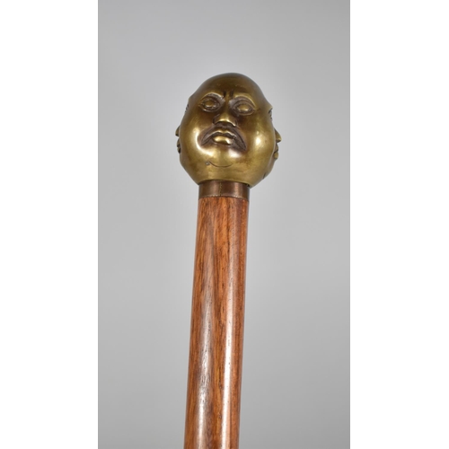 176 - A Reproduction Walking Cane with Four Faced Buddha Handle