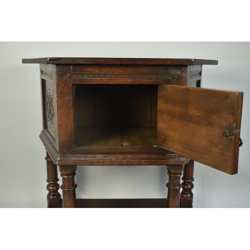 23 - A Mid 20th Century Oak Credence Table with Carved Hinged Front Door and Side Panels, Turned Supports... 