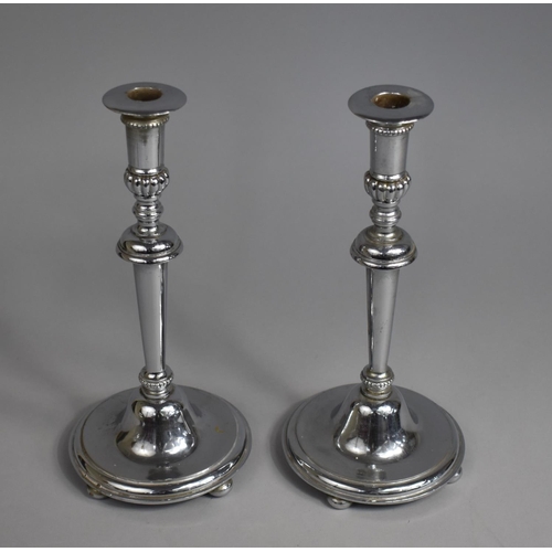 32 - A Pair of Silver Plated Candlesticks on Circular Bases with Four Bun Feet, 26cms High