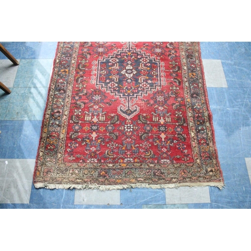 487 - A Patterned Rug on Red Ground, 191x134cms