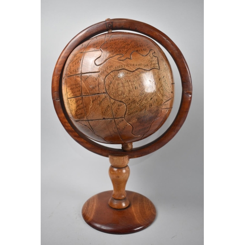 108 - A Late 20th Century Naive Carved Wooden Table-top Globe, 43cm High