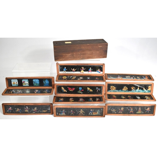 129 - A Vintage Wooden Box with Sliding Lid Containing Coloured Magic Lantern Strip Slides, 26cm Long