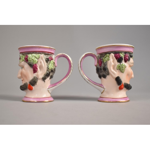 307 - A Pair of Porcelain Bacchanalian Mask Mugs, 10cm high