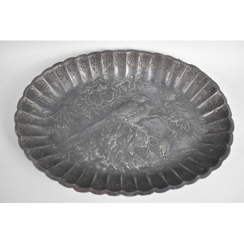 63 - A Japanese Pressed Metal Oval Dish with Relief Decoration in the Form of Pheasants and Flowers, Wavy... 