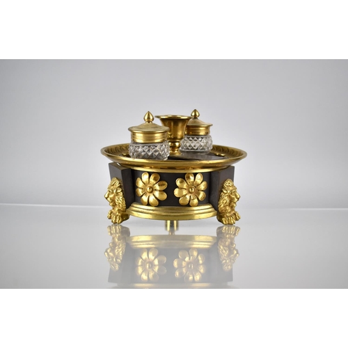 104 - A Regency Bronze and Gilt Ink Stand of Circular Footed Form complete with Two Cut Glass Inkwells Rai... 