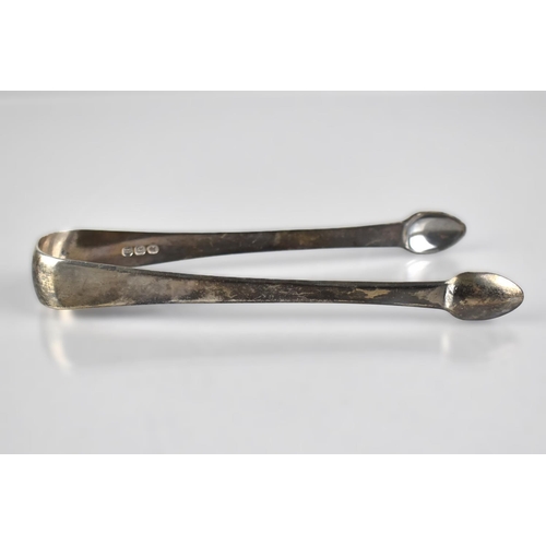 182 - A Georgian Silver Sugar Bow of Plain Form with Pad Nips and Monogram, 14cms Long