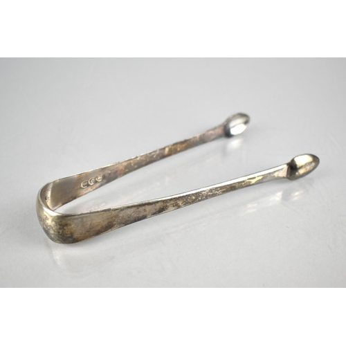 182 - A Georgian Silver Sugar Bow of Plain Form with Pad Nips and Monogram, 14cms Long