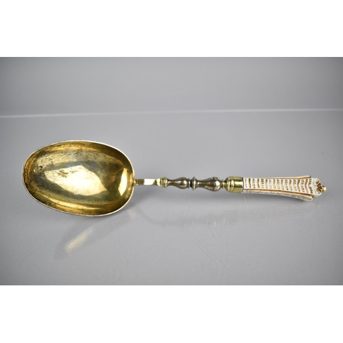 195 - An 18th Century Silver Parcel Gilt and Porcelain Handled Serving Spoon, The White Glazed Porcelain H... 