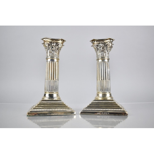 143 - A Pair of Edward VII Silver Corinthian Column Candlesticks by Barker Brothers on Stepped Square Plin... 