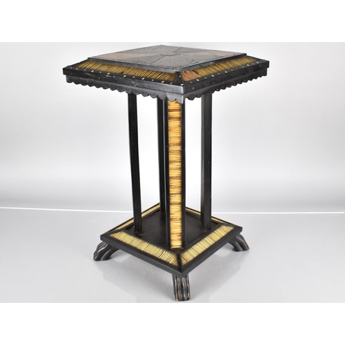 49 - A 19th Century Ceylonese Ebony Table with A Specimen Wood Top, Over Four Legs and Platform Base with... 