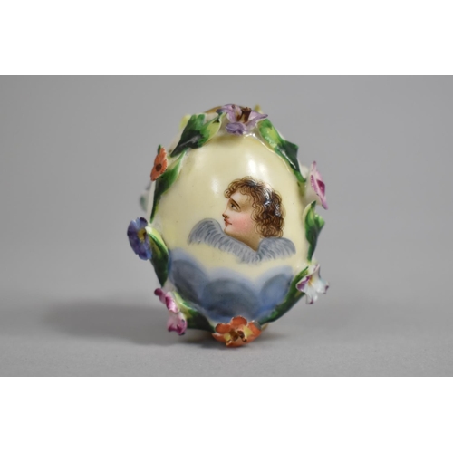 376 - A 19th/20th Century Russian Porcelain Easter Egg with Encrusted Bocage and with Hand Painted Cherub ... 