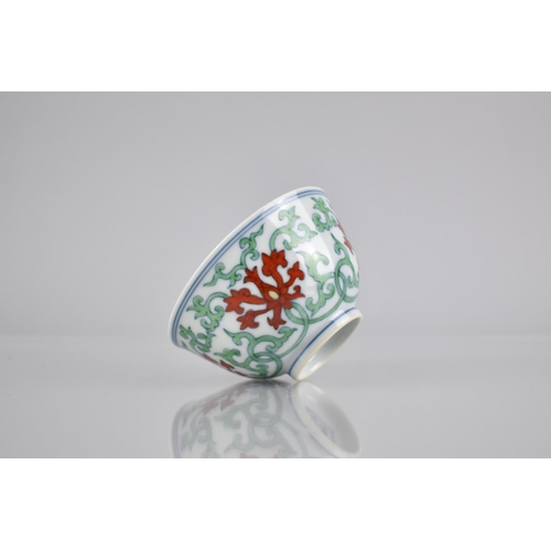 268 - A Chinese Porcelain Doucai Tea Bowl Decorated in a Floral and Scrolled Motif, Six Character Mark to ... 