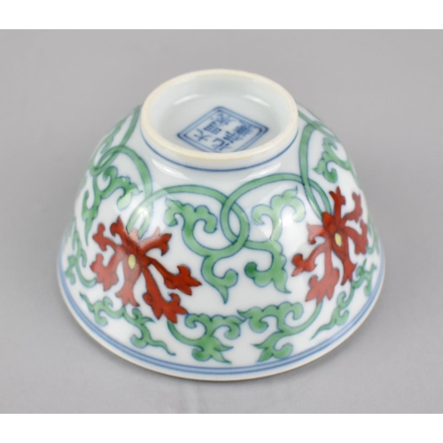 268 - A Chinese Porcelain Doucai Tea Bowl Decorated in a Floral and Scrolled Motif, Six Character Mark to ... 