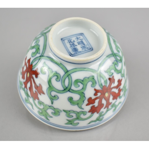 268 - A Chinese Porcelain Doucai Tea Bowl Decorated in a Floral and Scrolled Motif, Six Character Mark to ... 