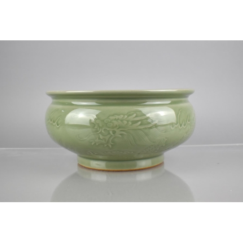 216 - A Chinese Celadon Glaze Censer with Underglaze Dragon Chasing Flaming Pearl, with Lipped Rim and Sho... 