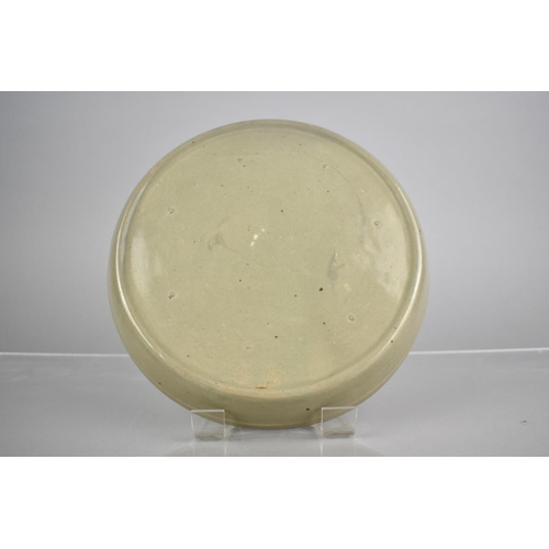 213 - A Chinese Longquan Celadon Type Dish Decorated in Shallow Relief with Phoenix, Lipped Rim, Seven Spu... 