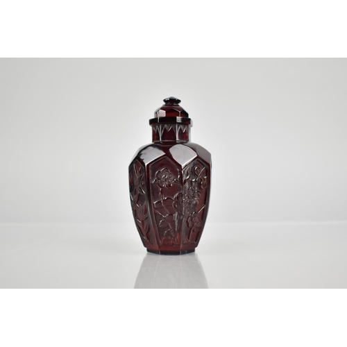 345 - A Chinese Cherry Amber Snuff Bottle of Octagonal Baluster Form with Floral Motif Panels, 9cm High.