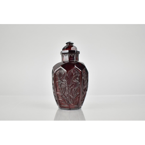 345 - A Chinese Cherry Amber Snuff Bottle of Octagonal Baluster Form with Floral Motif Panels, 9cm High.